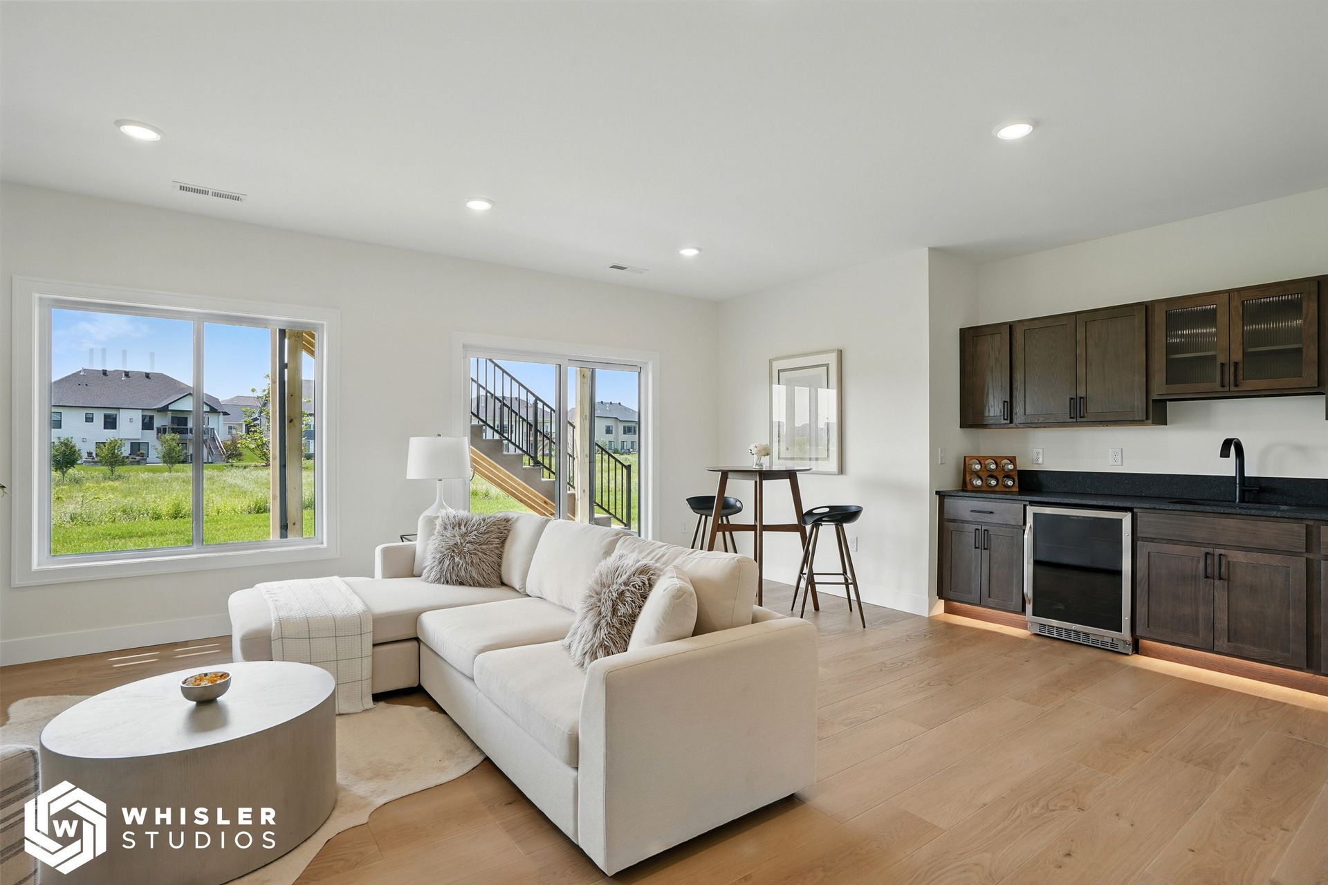 A living room with a couch, coffee table, and kitchen.