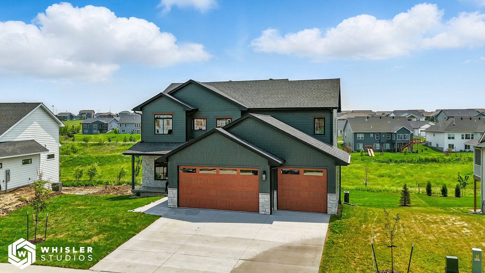 An aerial view of a house with two garage doors in a residential area.