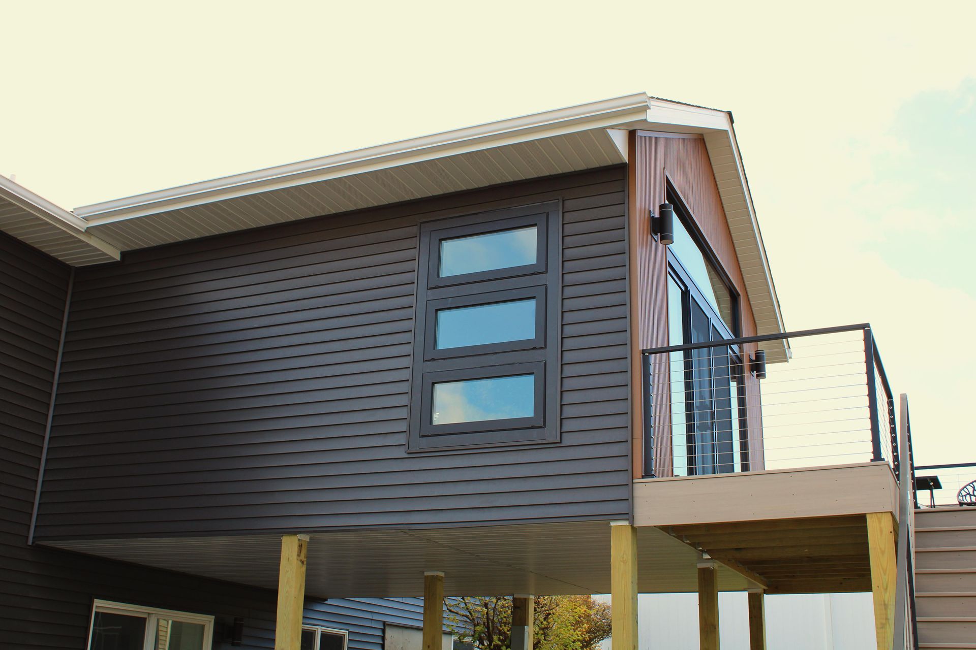 A house with a balcony and stairs on the side of it.