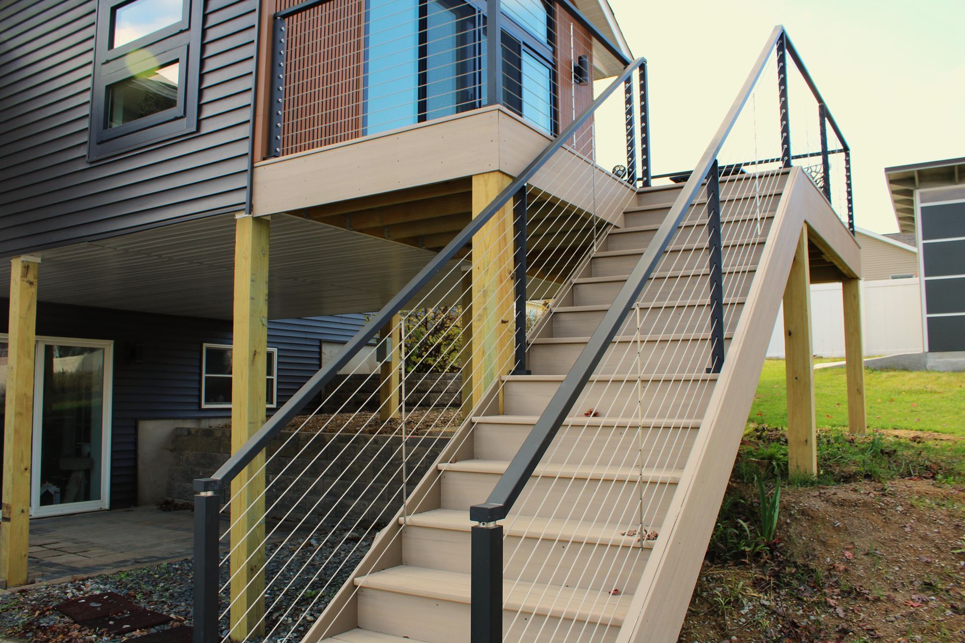 A set of stairs leading up to a deck of a house.