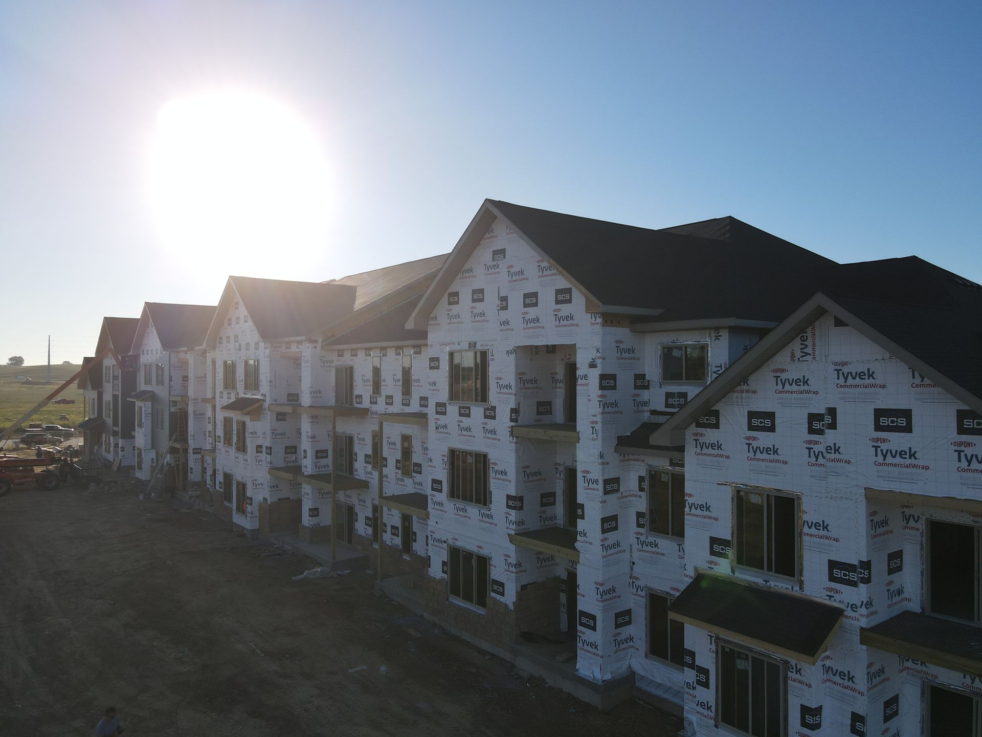 An aerial view of a building under construction with the sun shining through the windows