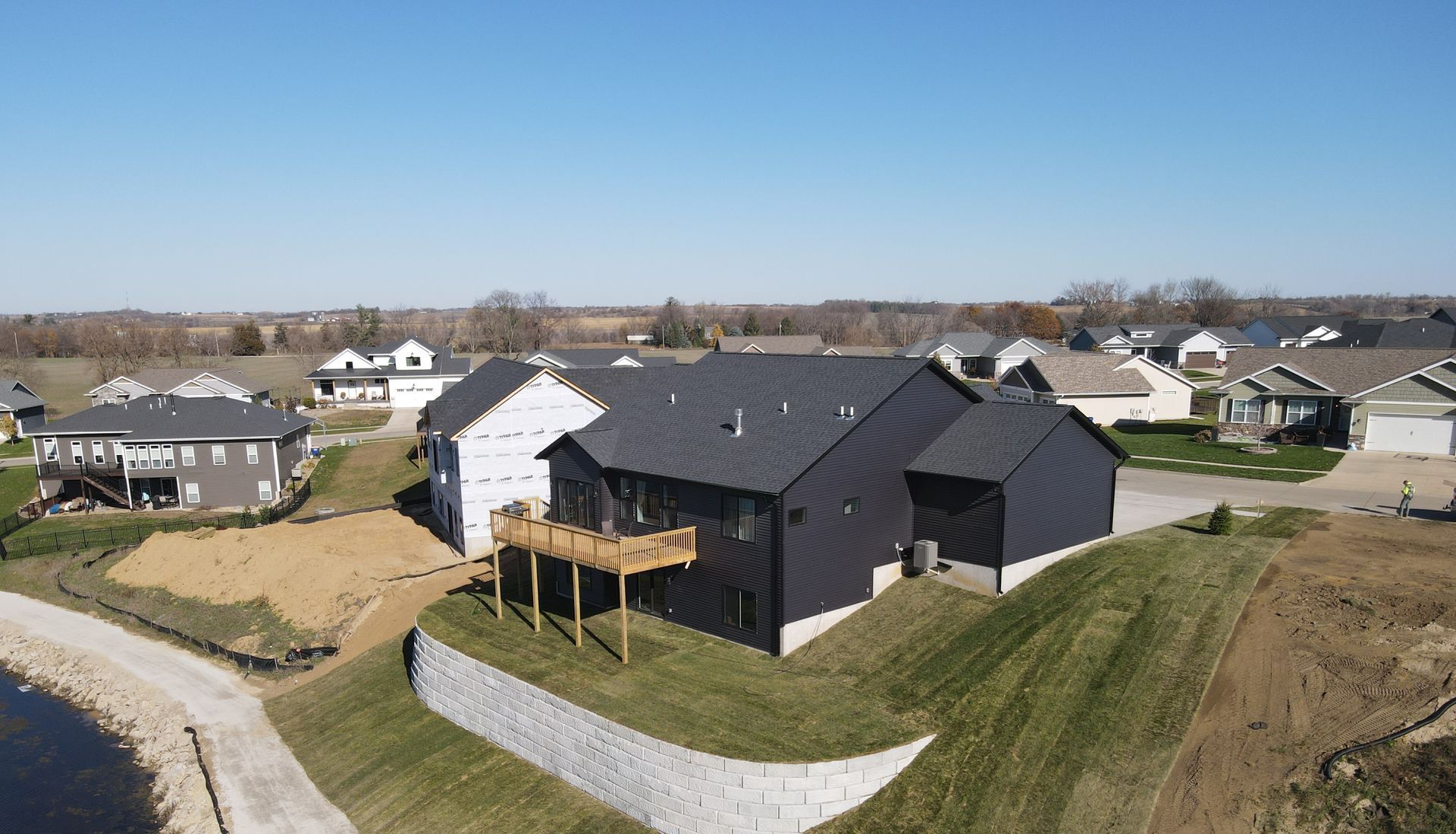 An aerial view of a house with a deck in a residential area.