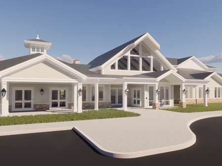 Exterior of a white, modern senior living facility with gray roof, green grass, and blue sky.