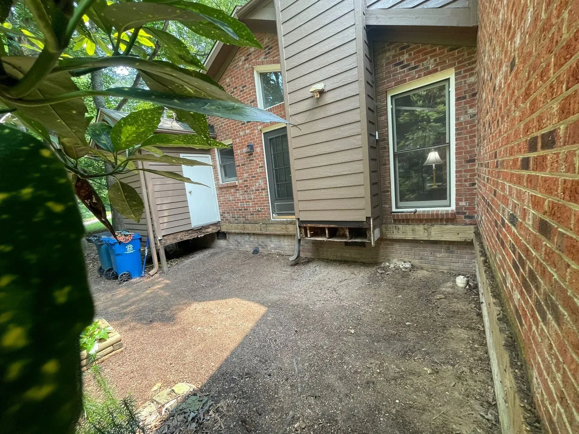 A brick house with a patio in front of it.