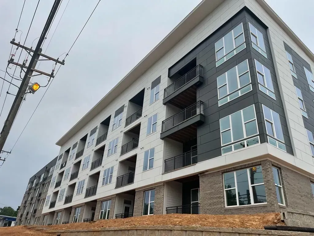 A large building with a lot of windows is under construction.