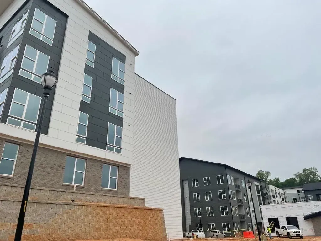 A large building with a lot of windows is under construction.