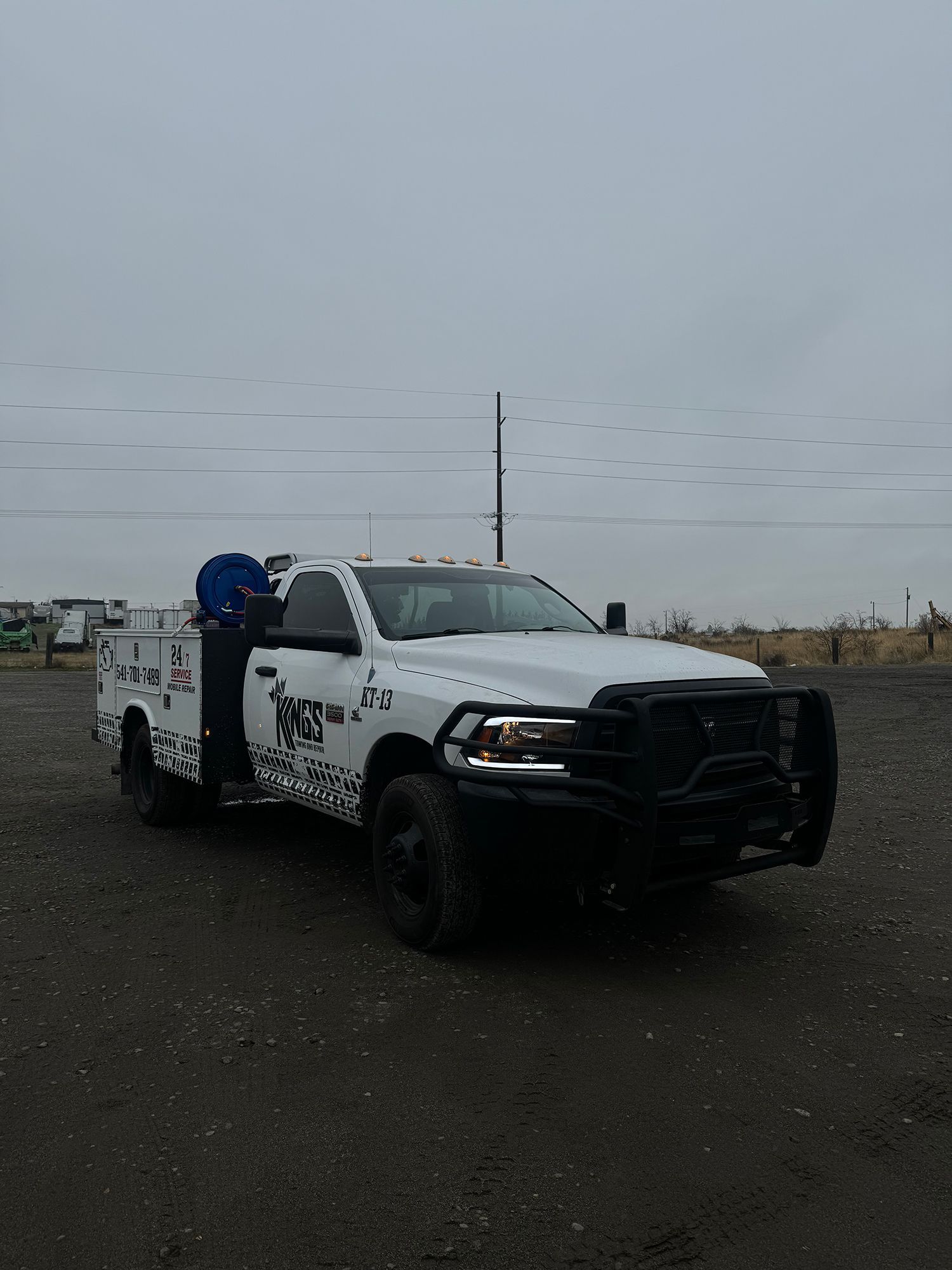 A white truck is parked in a parking lot.