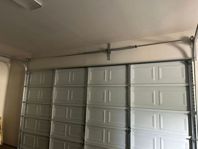 Closed gray garage door in a beige garage interior