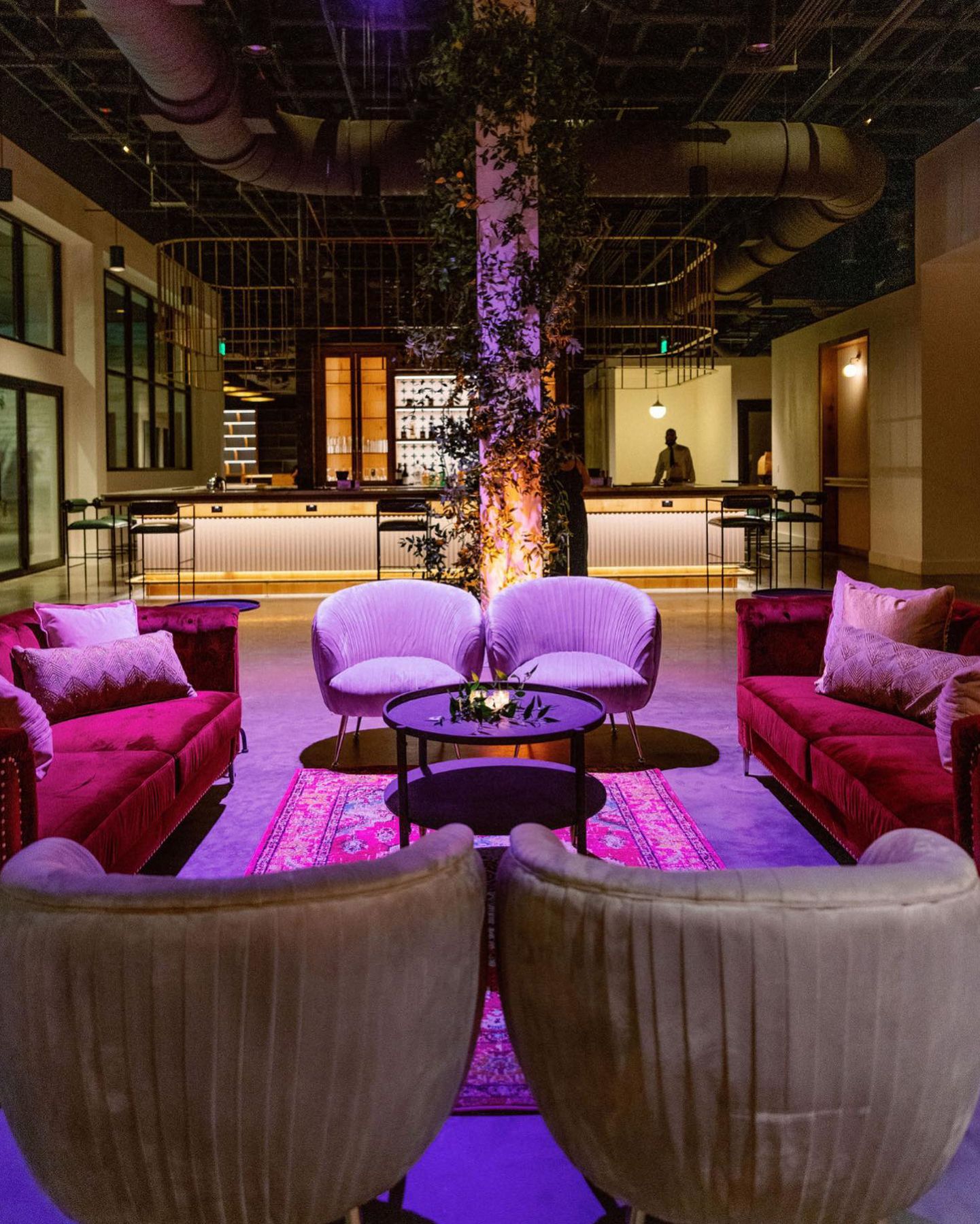 A living room filled with furniture and a purple light