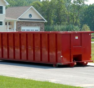 A red roll-off container