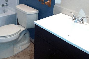 A bathroom with a toilet a sink and a bathtub