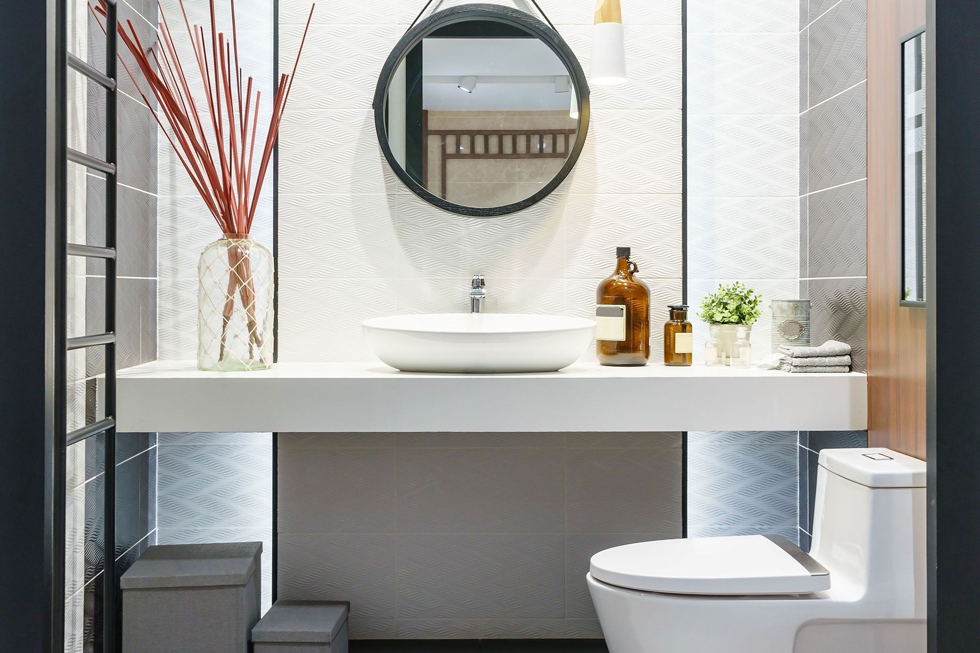 A bathroom with a toilet, sink and mirror