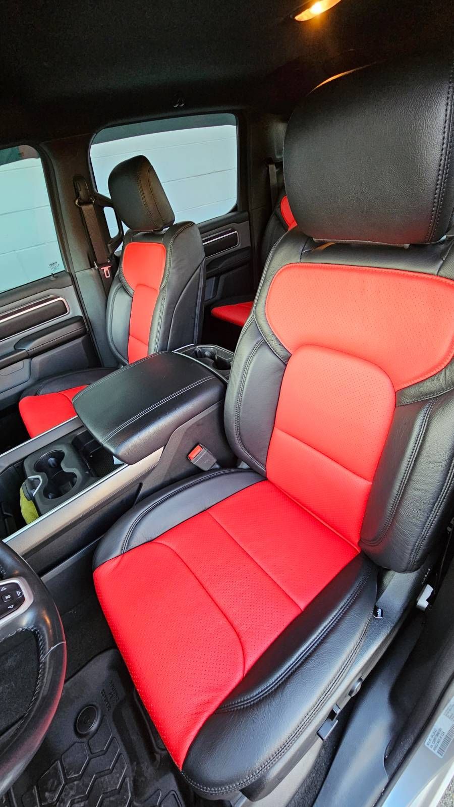 Car interior with black-and-red seat covers and matching rear seats