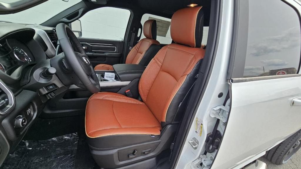 Brown leather front car seats and dashboard with the passenger door open