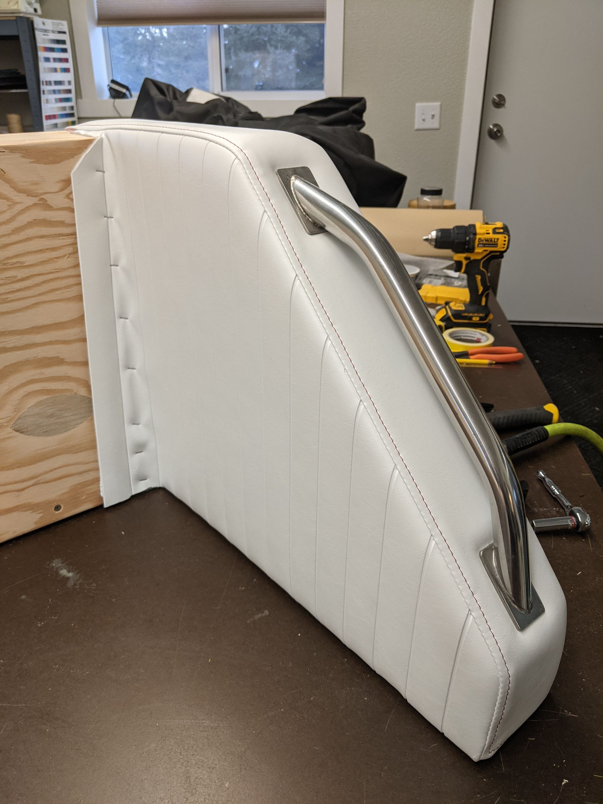 A piece of styrofoam with a metal handle is sitting on a table