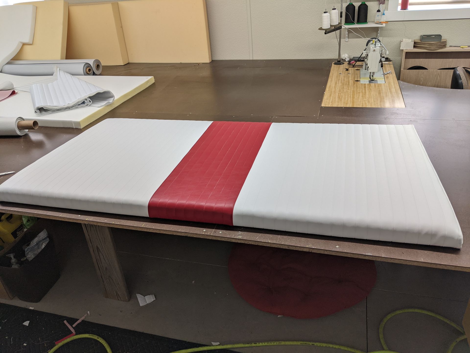 A white mattress with a red stripe on it