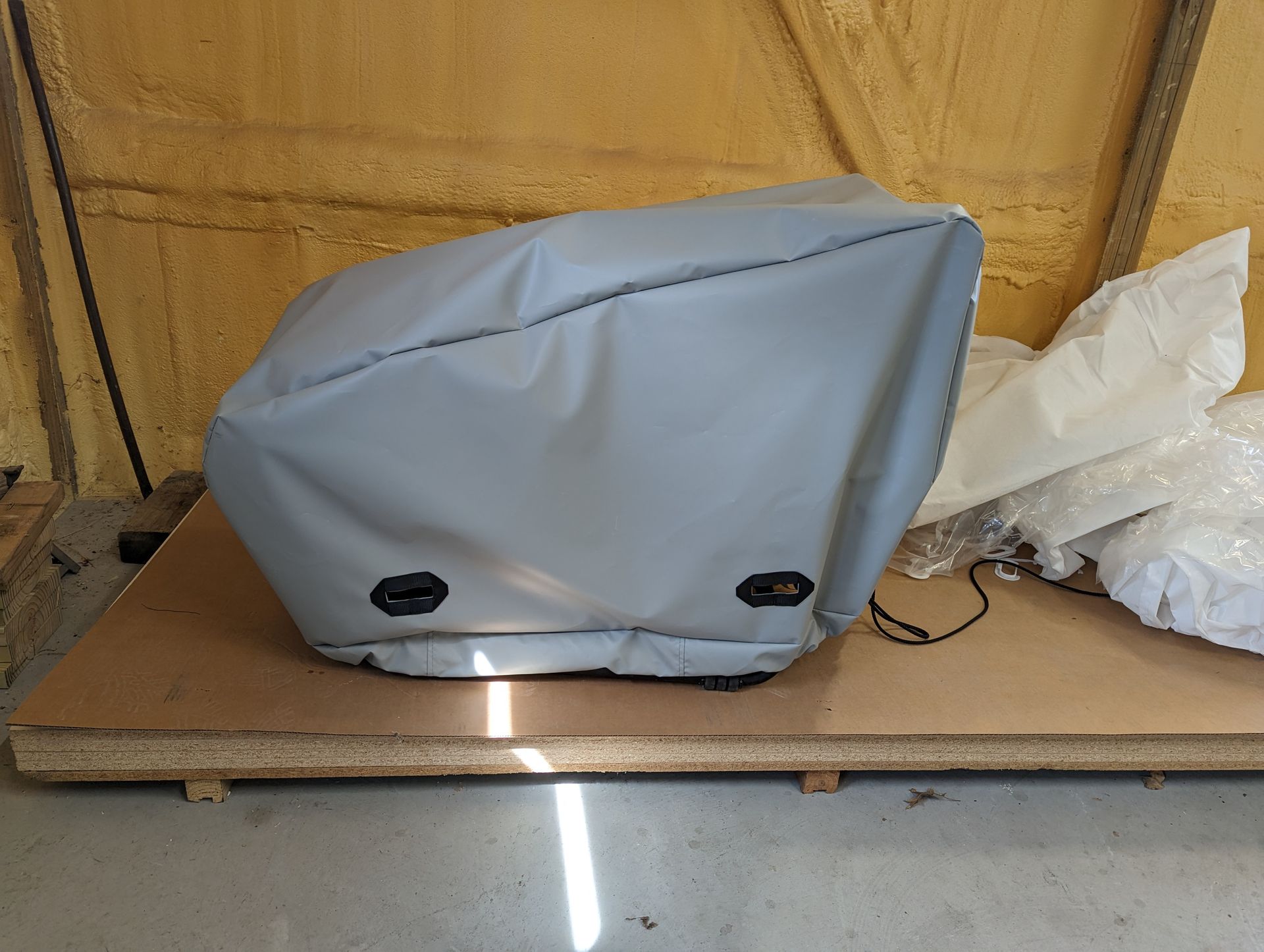 A gray item is sitting on top of a wooden table.