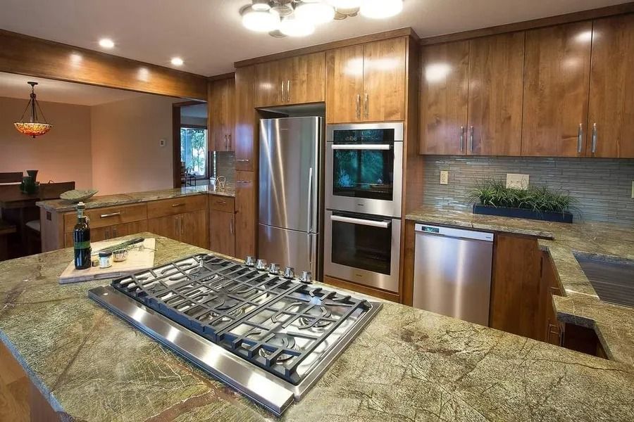 Kitchen with wooden cabinets, stainless steel appliances, and granite countertops.