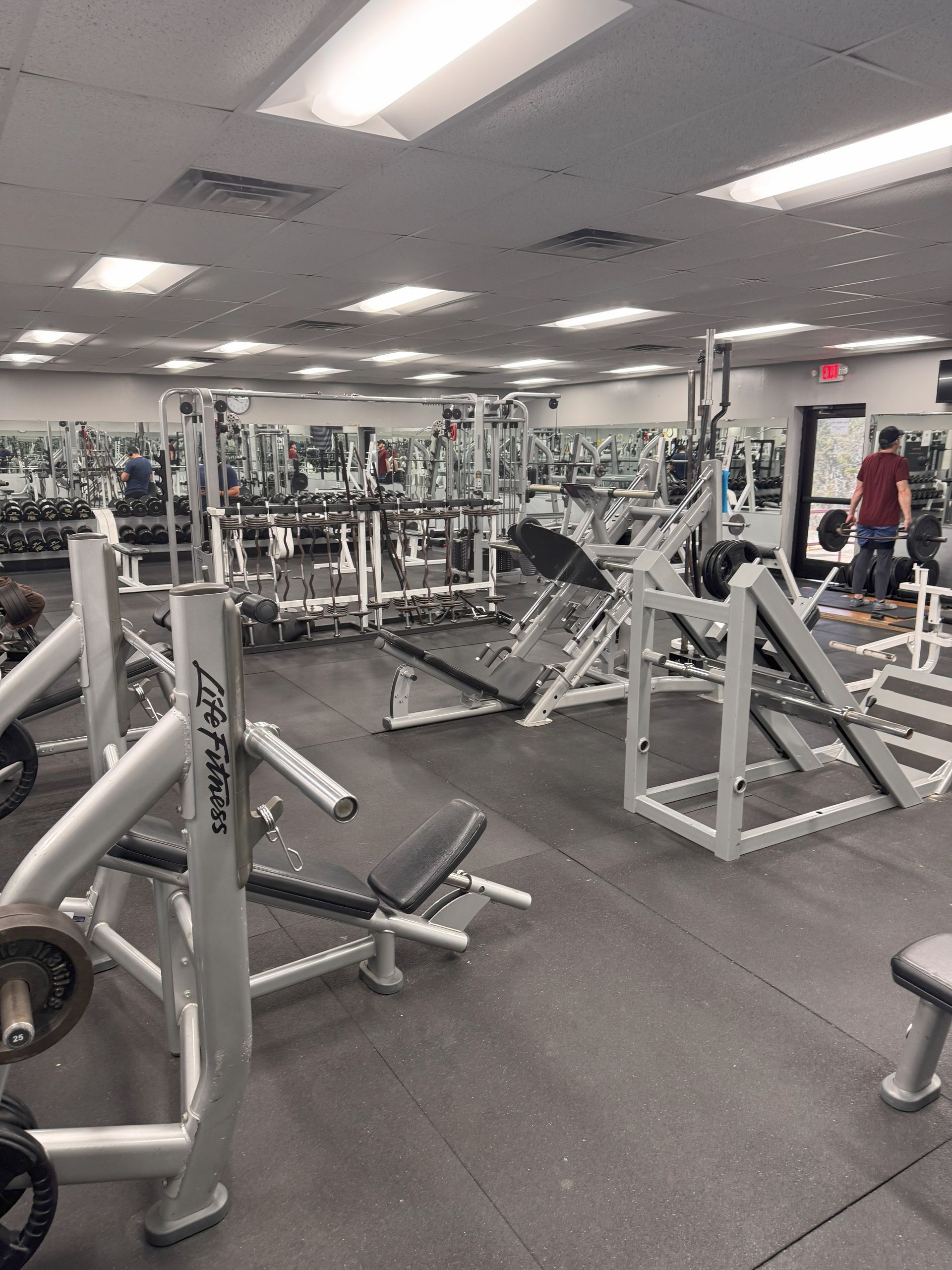 A large gym filled with lots of exercise equipment