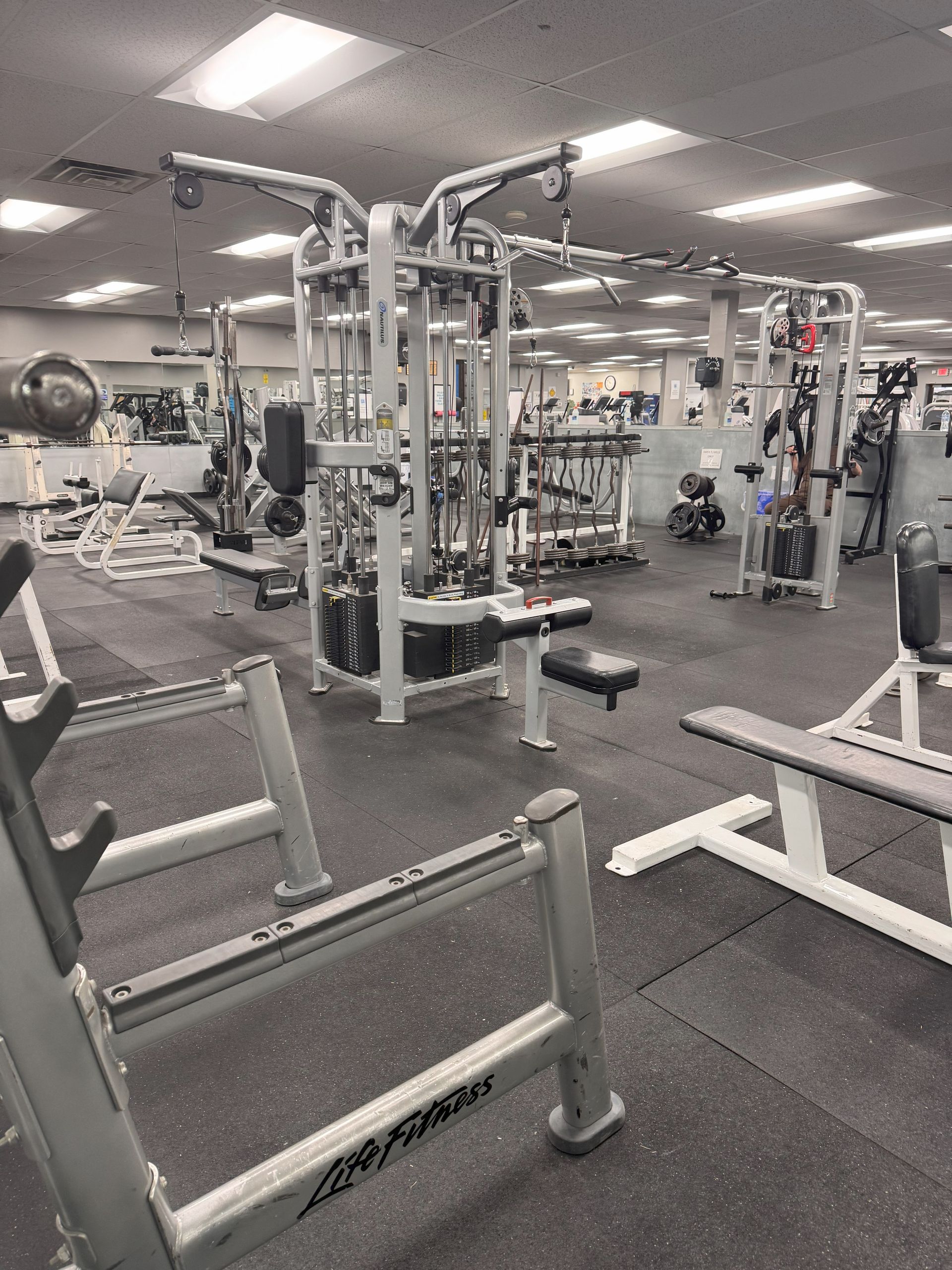 A large gym filled with lots of exercise equipment