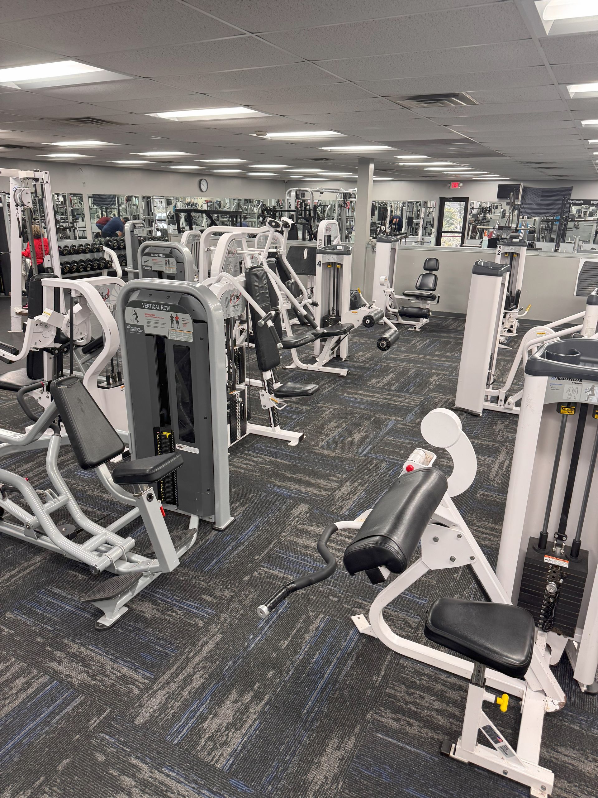 A large gym filled with lots of exercise equipment