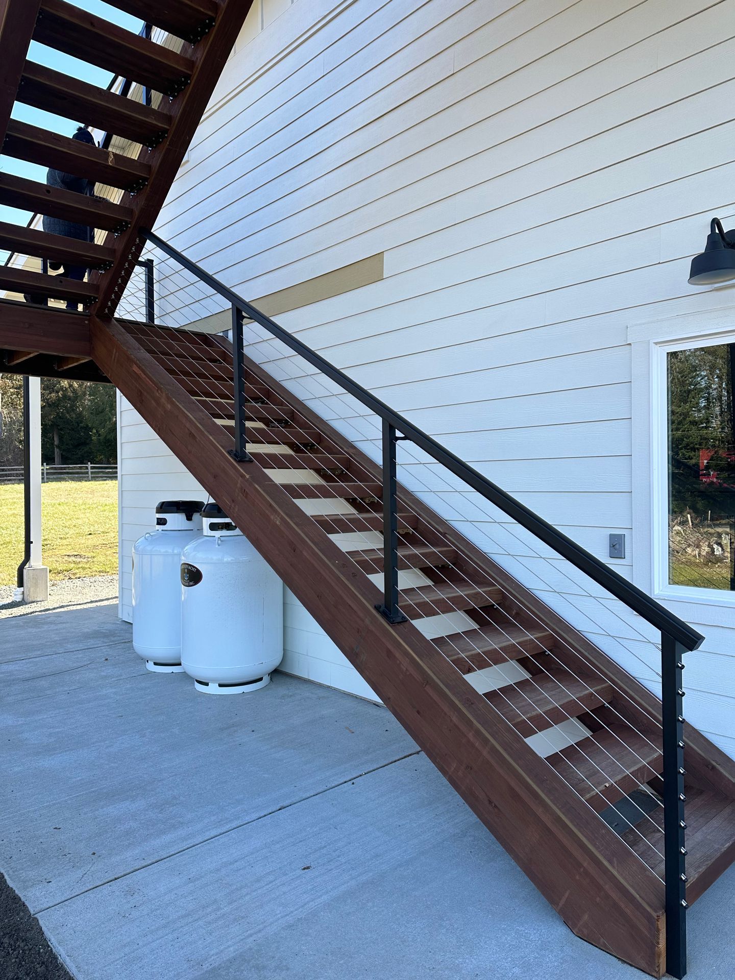 Brown stairs with cable railing