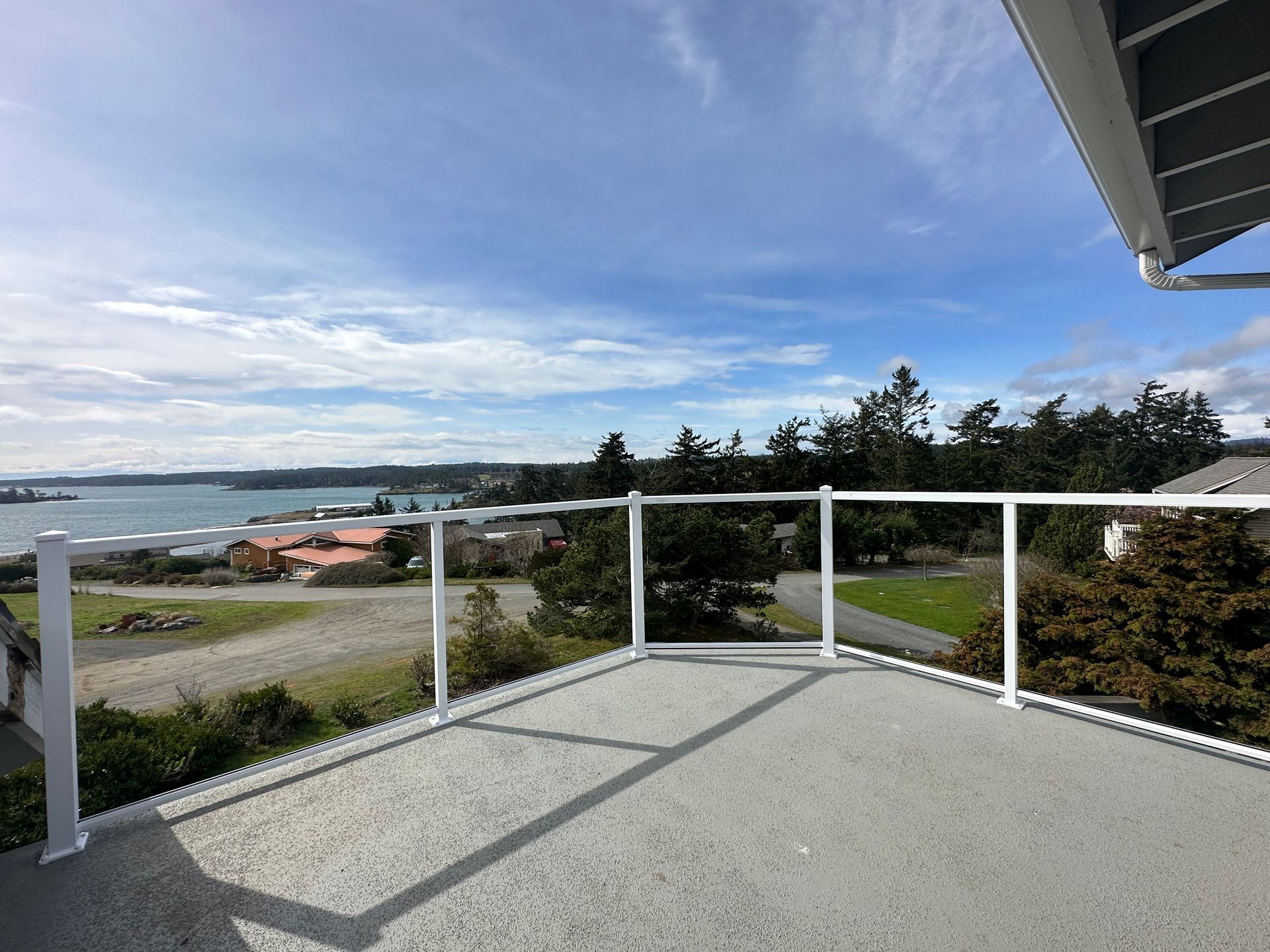 Newly installed white glass panel railings