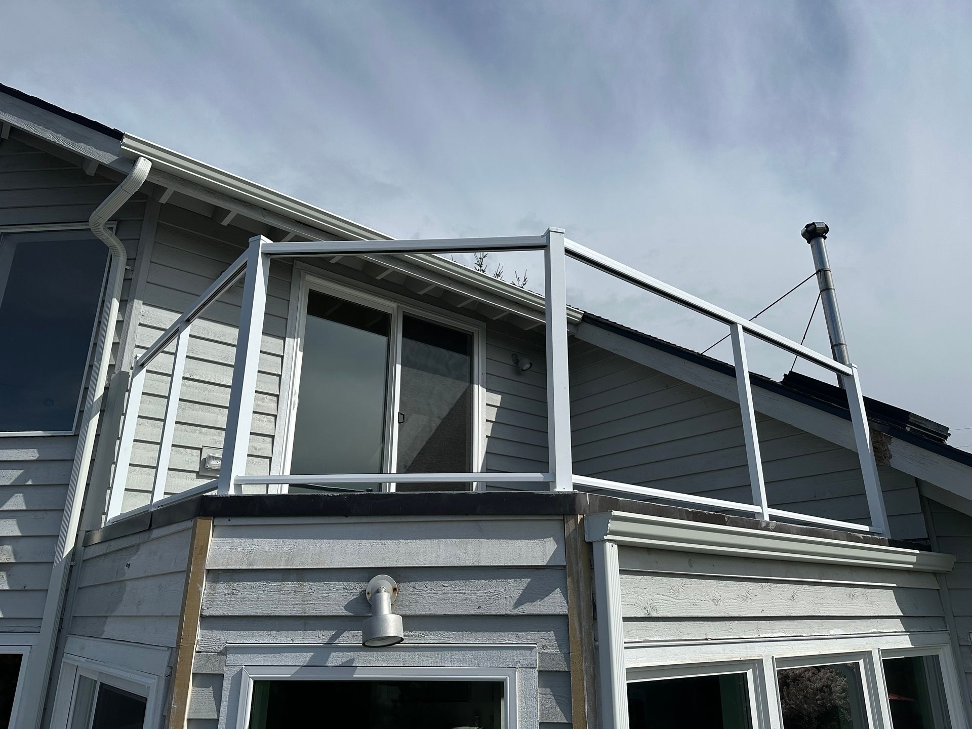 Newly installed white glass panel railing