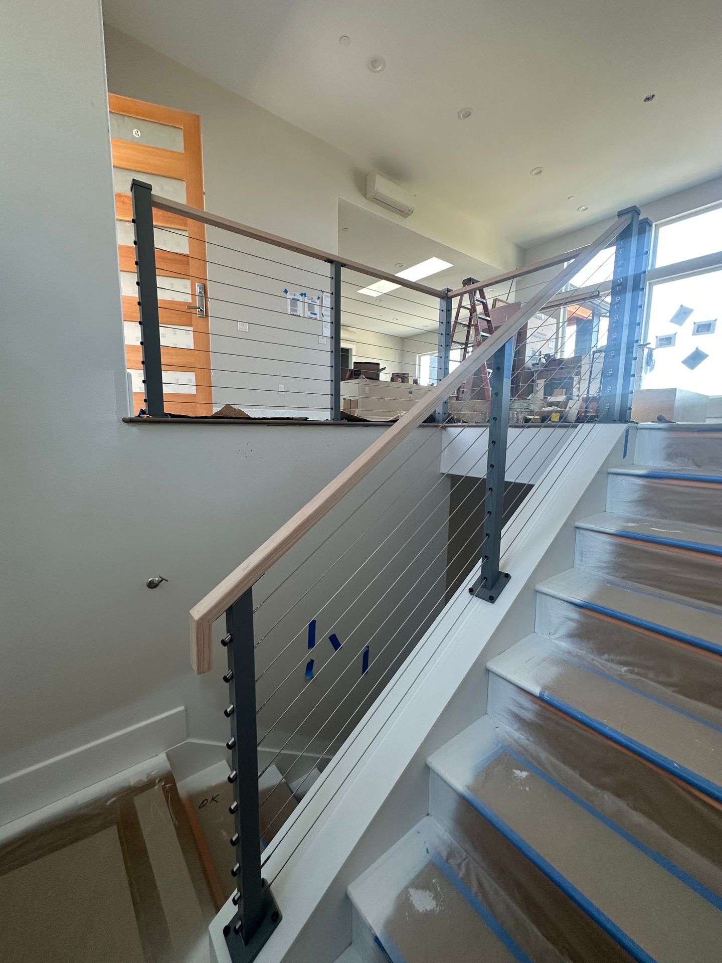 Wood stair with gray railing