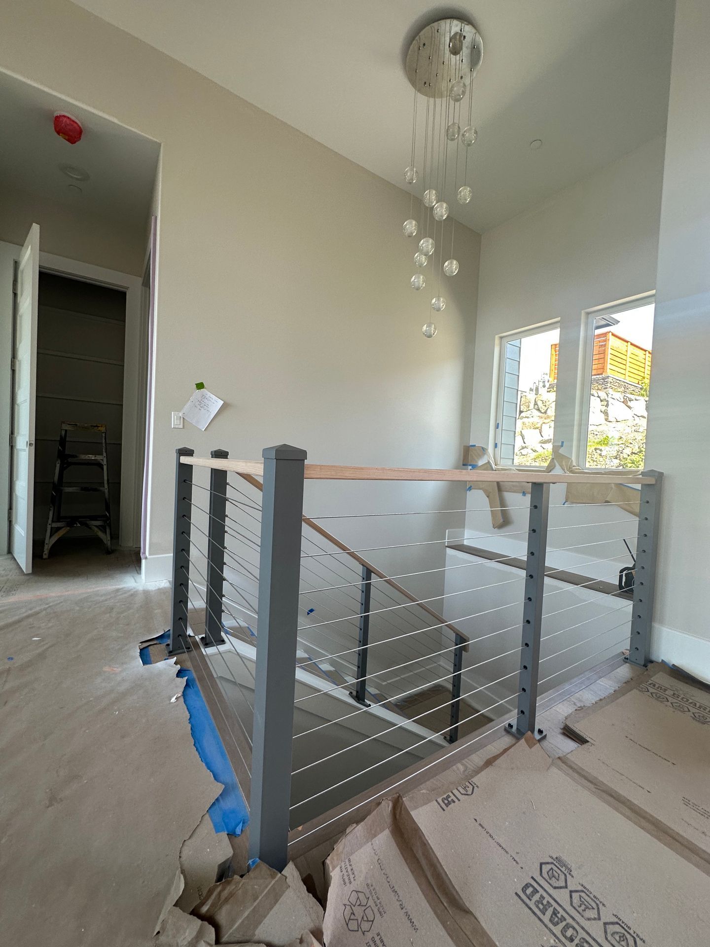 Wood stair with gray railing installations