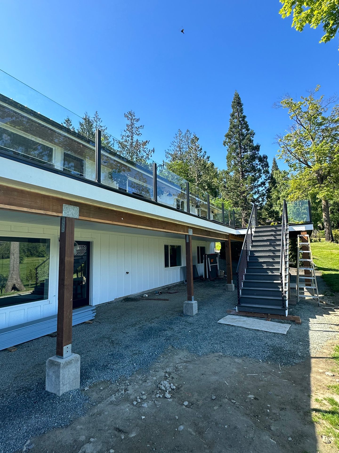 Custom-built glass railing with black posts