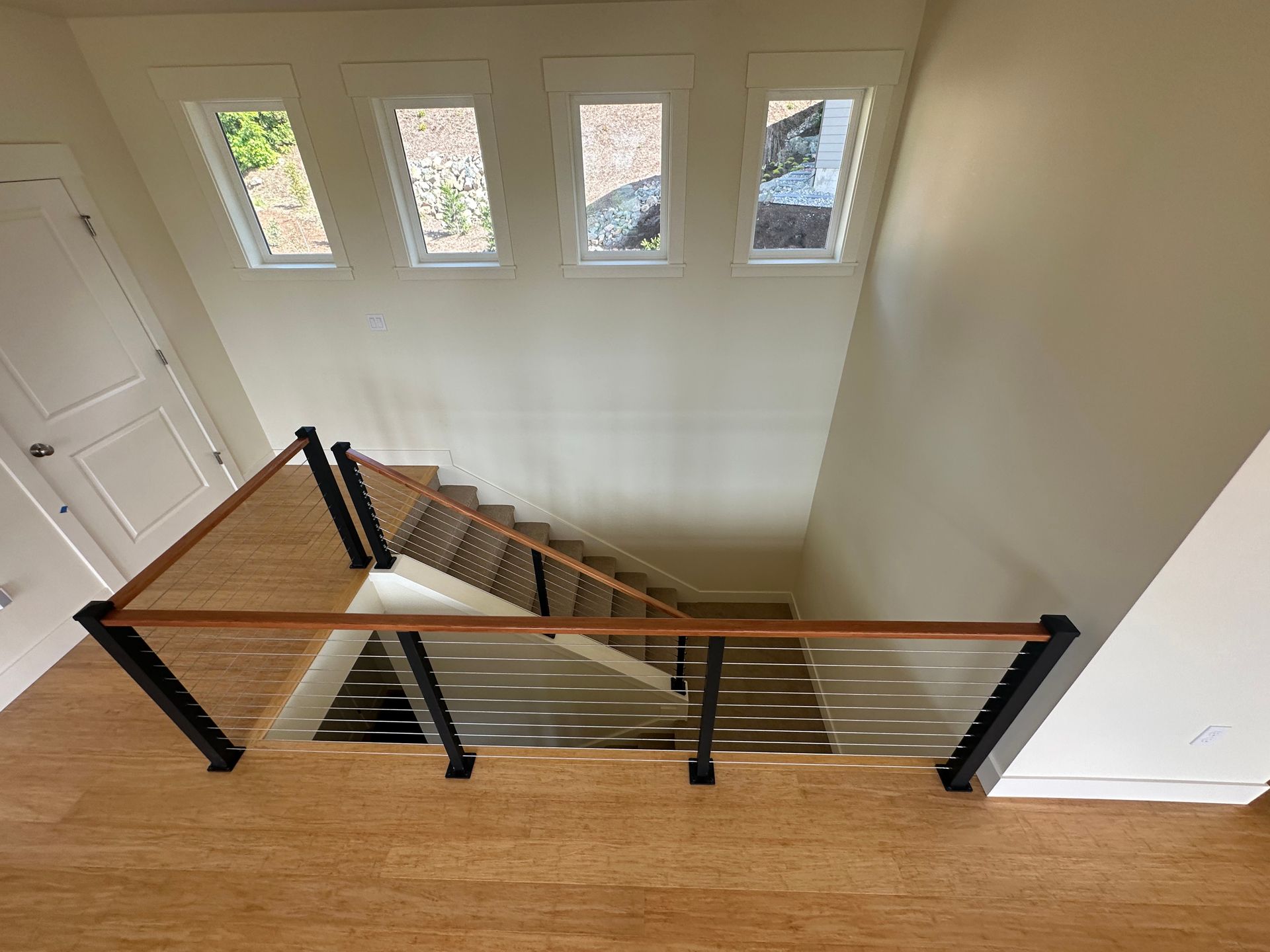 Brand new wood stair with cable railings