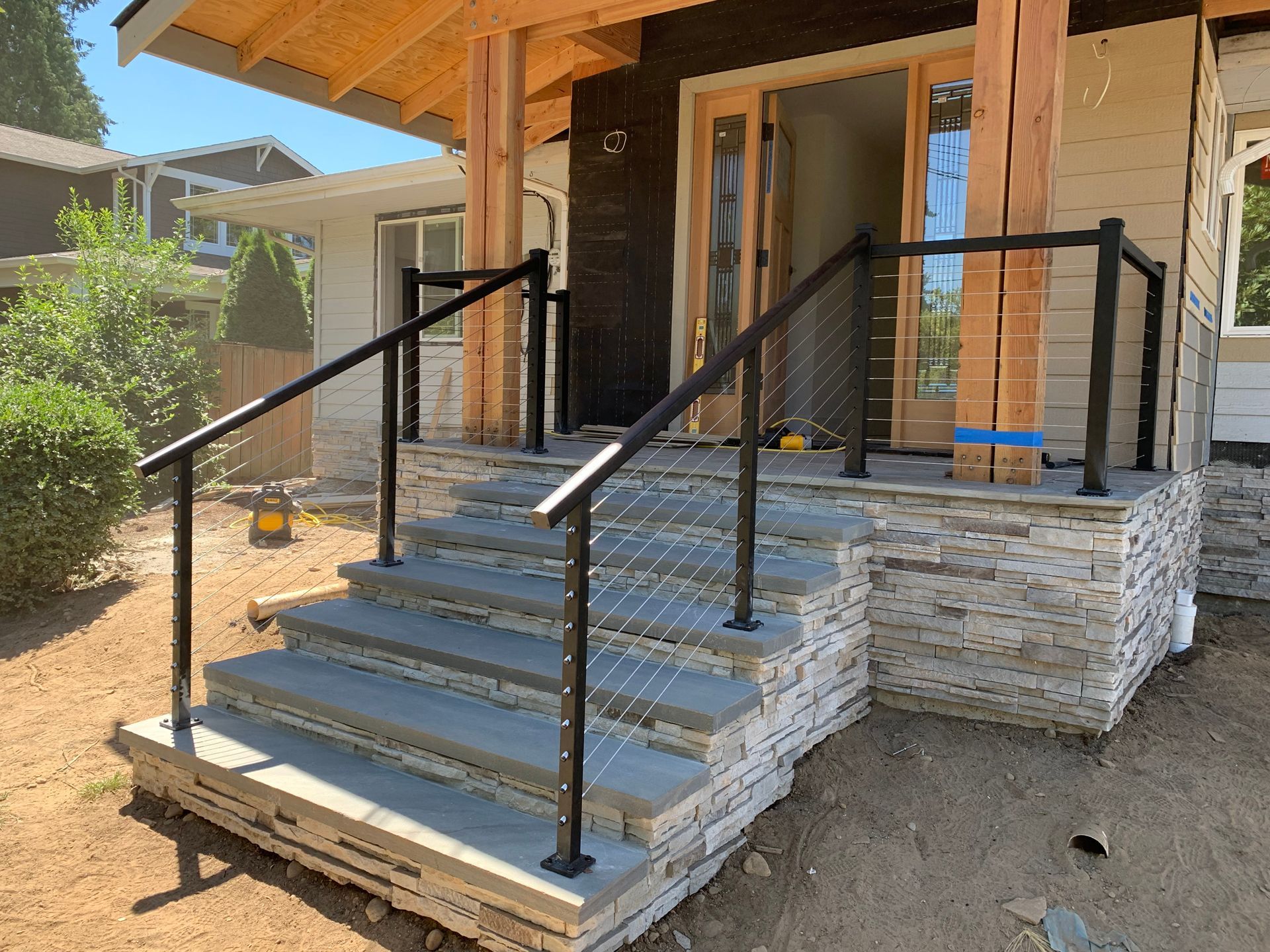 Newly built custom stair with black stainless railing