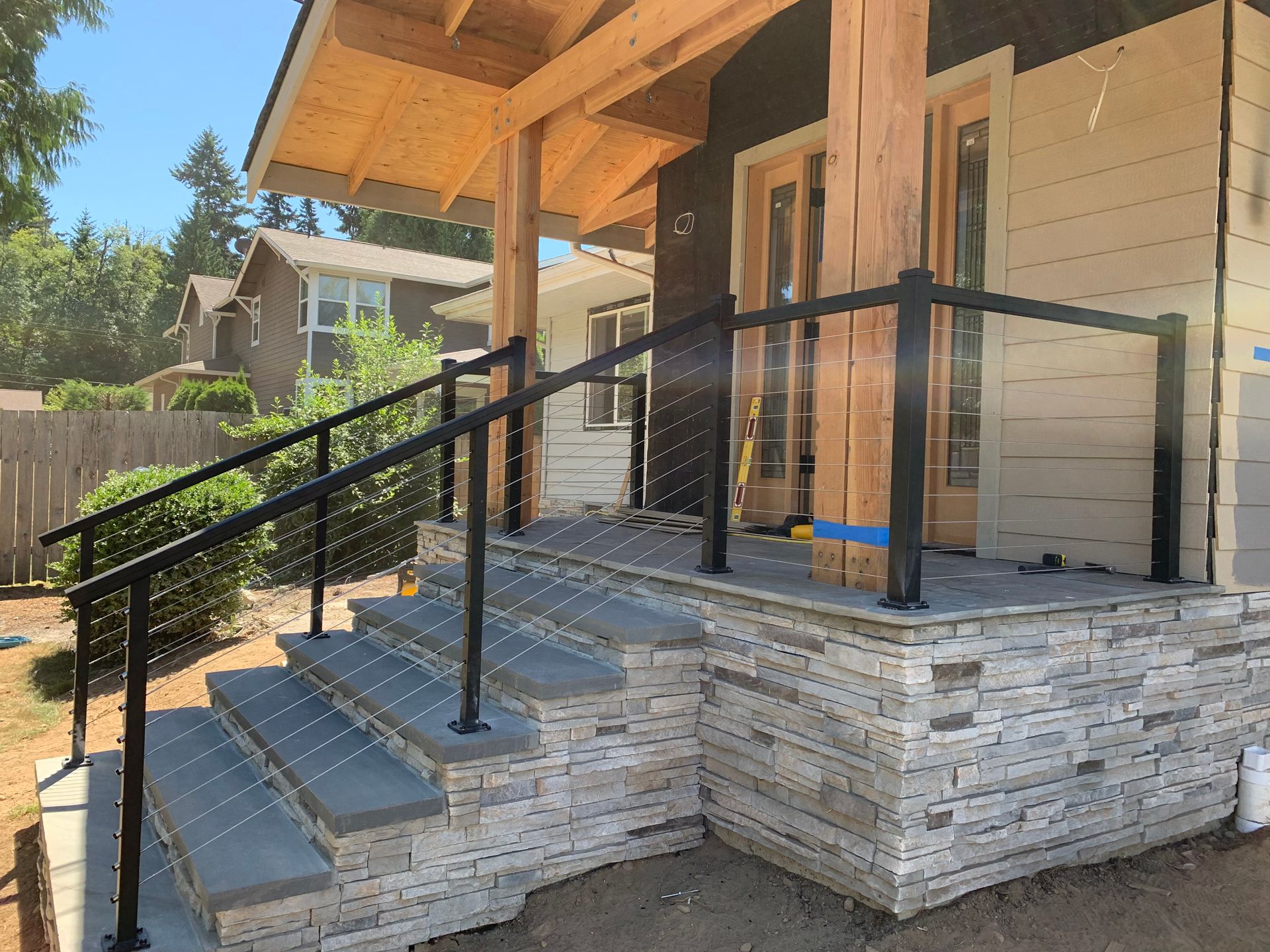Newly built custom stair with black stainless railings