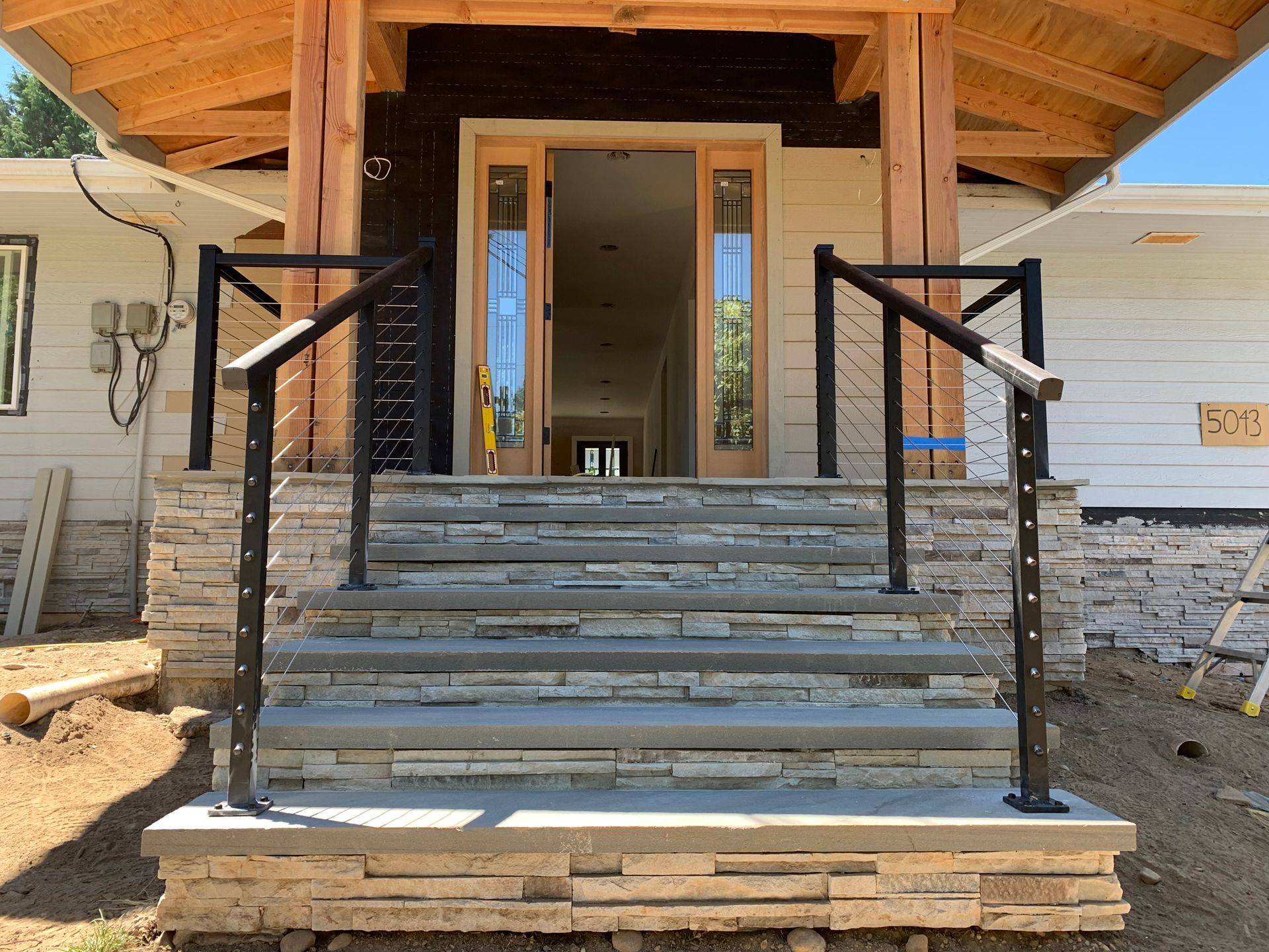 Newly built custom stair with black stainless cable railings