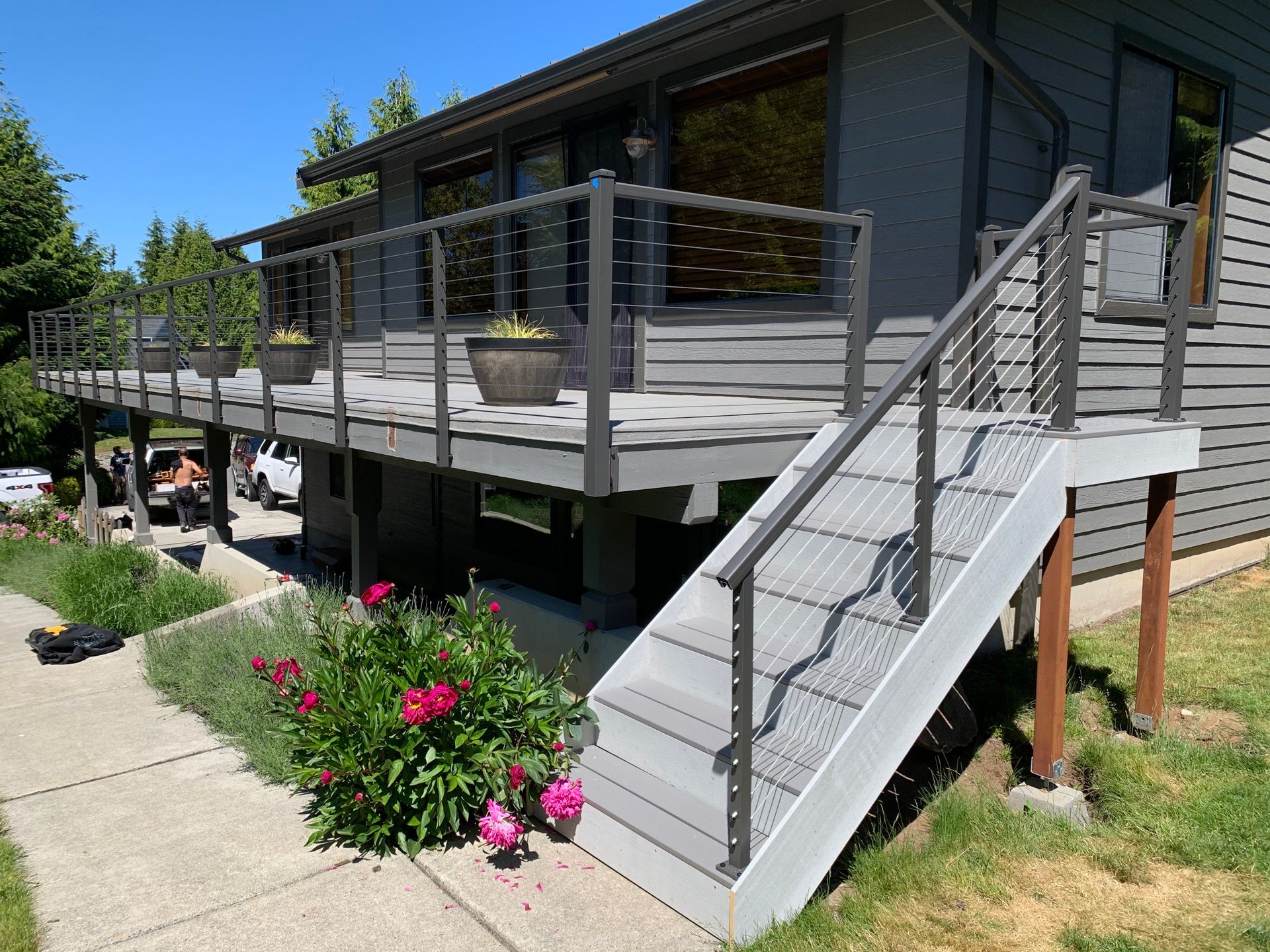 New wood deck floors installed with custom cable railing