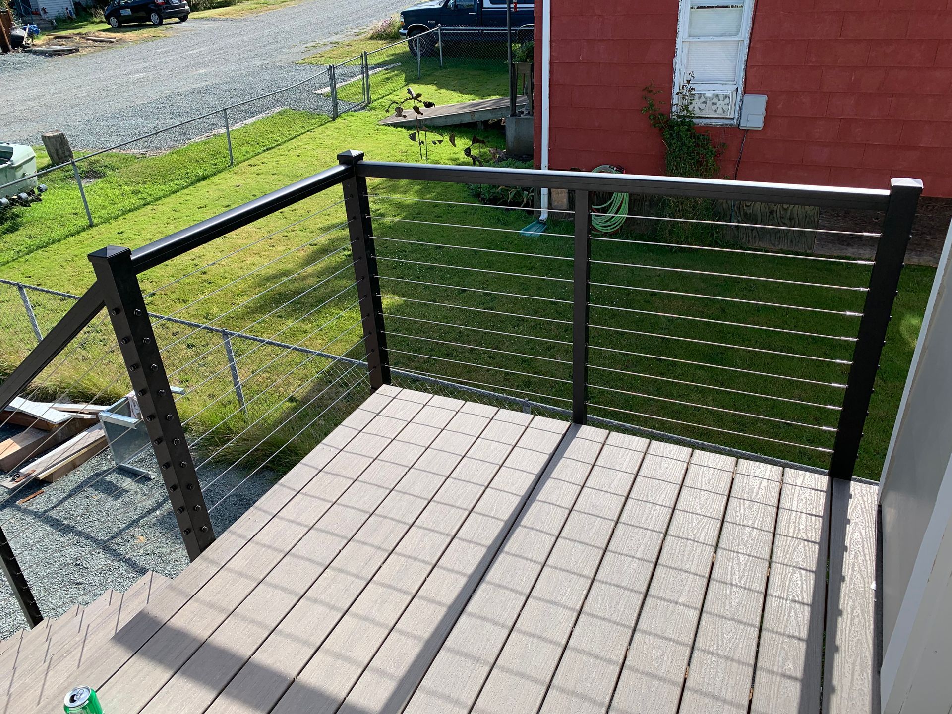 New wood deck floors installed with custom cable railings