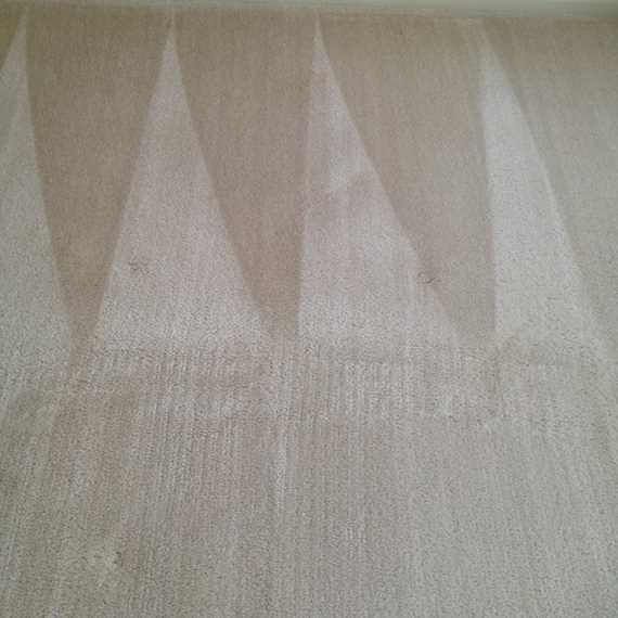 Three pale triangular sail-like shapes on a beige textured background
