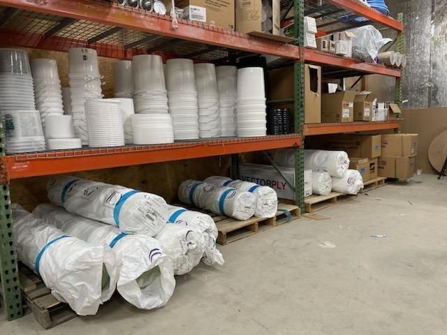 A warehouse filled with lots of containers and boxes.