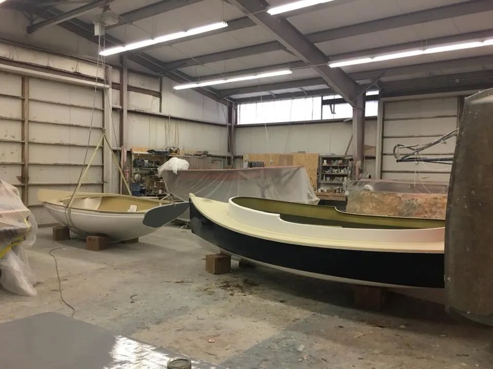 Two boats are being built in a building.