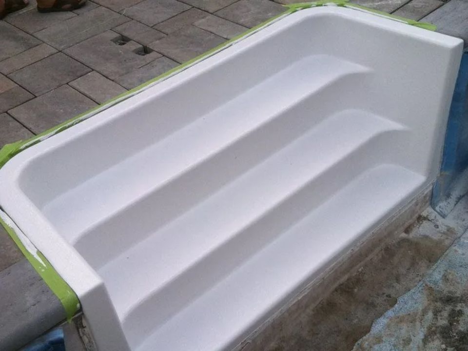 A white staircase with green tape on it