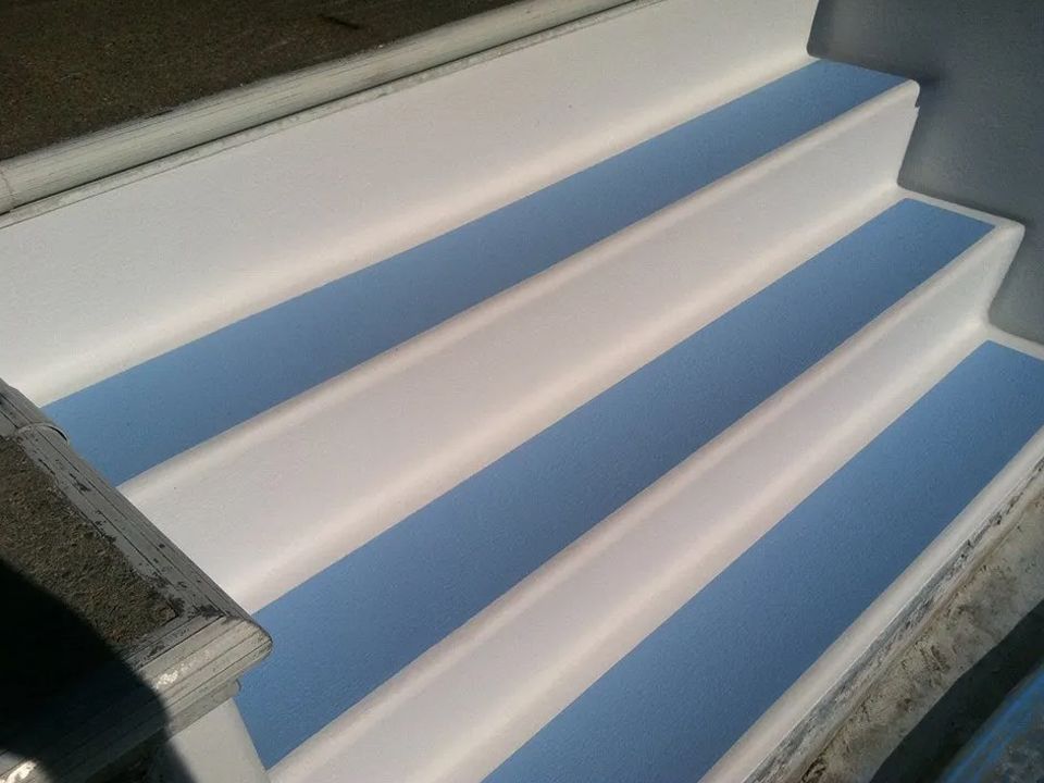 A set of white stairs with blue steps