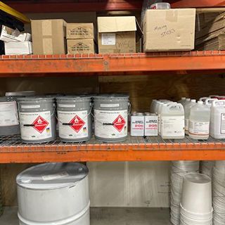 A shelf filled with buckets , containers , and boxes.
