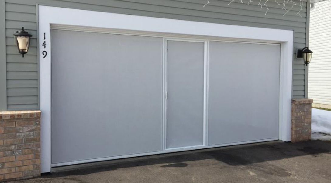 Garage with white screen door, gray siding, and house number 149.