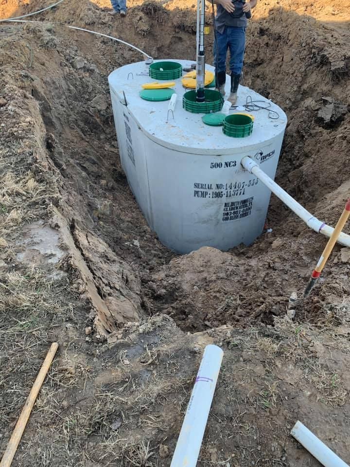 A septic tank is being installed in a hole in the ground.