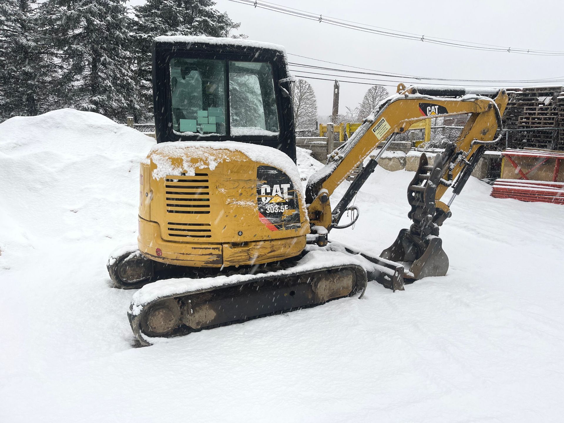 Mini excavator on a snowy field