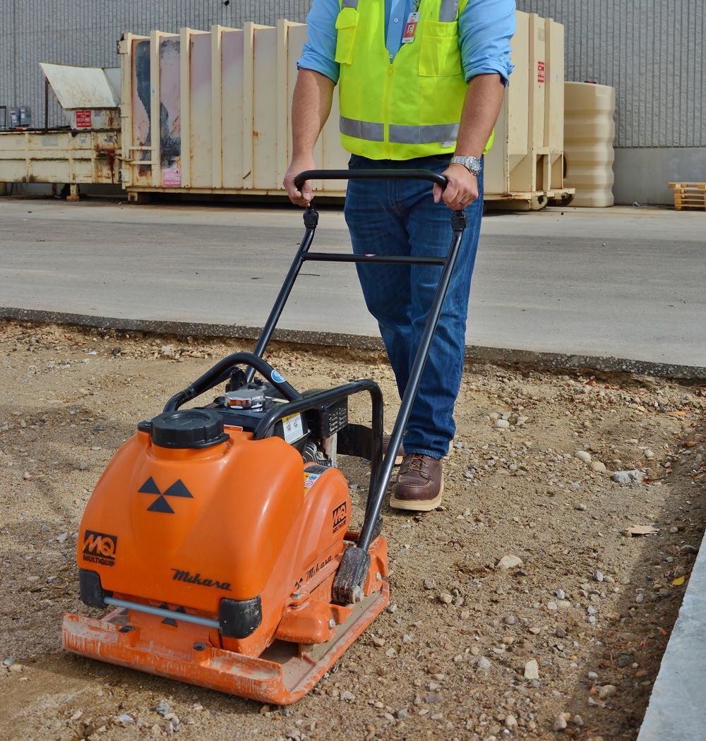 Man using a plate compactor