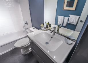 A bathroom with a sink, toilet, bathtub, and mirror