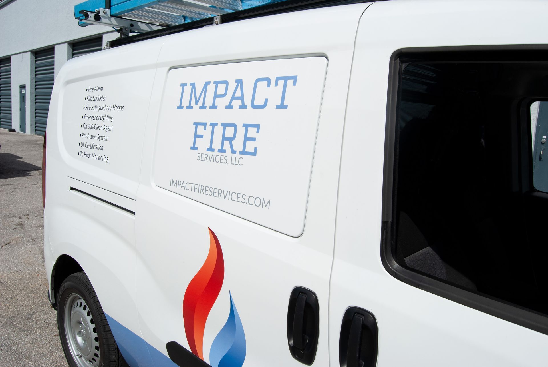 A white van with the word impact fire on the side