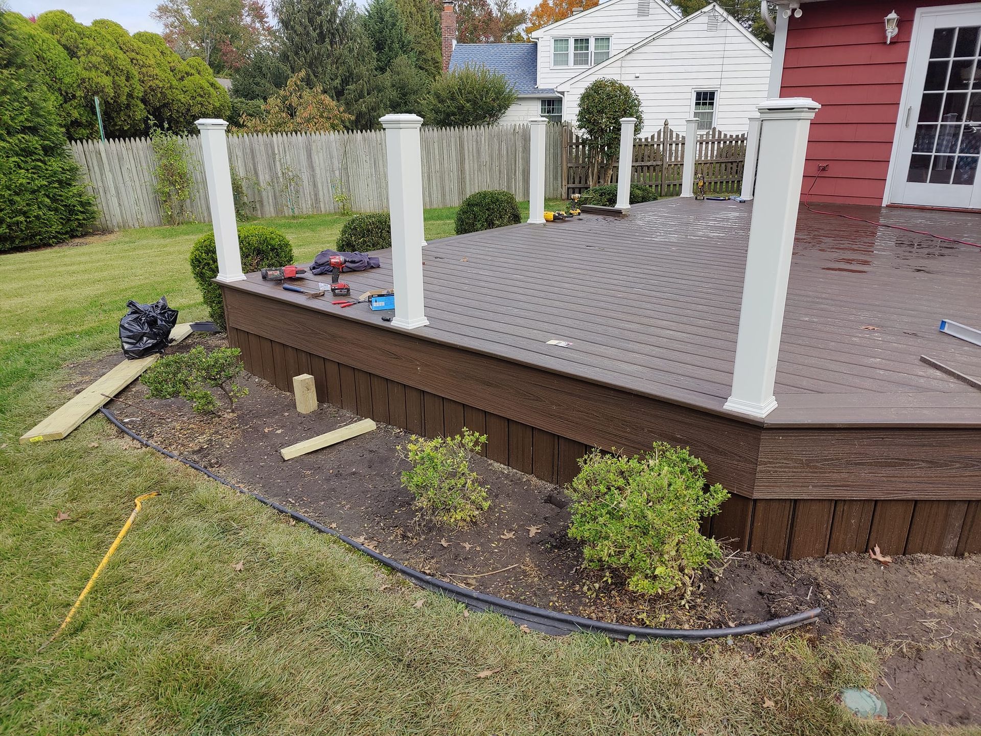 A deck is being built in the backyard of a house.